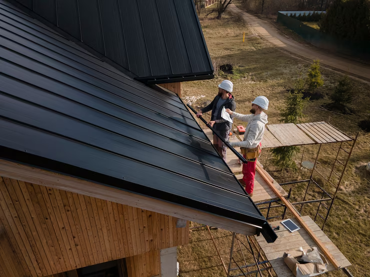 Two professionals working on the installation of a new roof. Get in touch with us today for an estimate.
