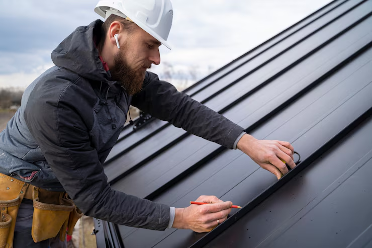 A professional roofer taking measurements before the final roof installation. Get you free estimate today.