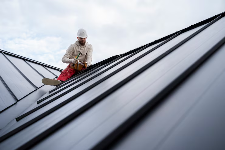 An expert roof installer working on a rooftop with precision. Call us today for a free estimate.