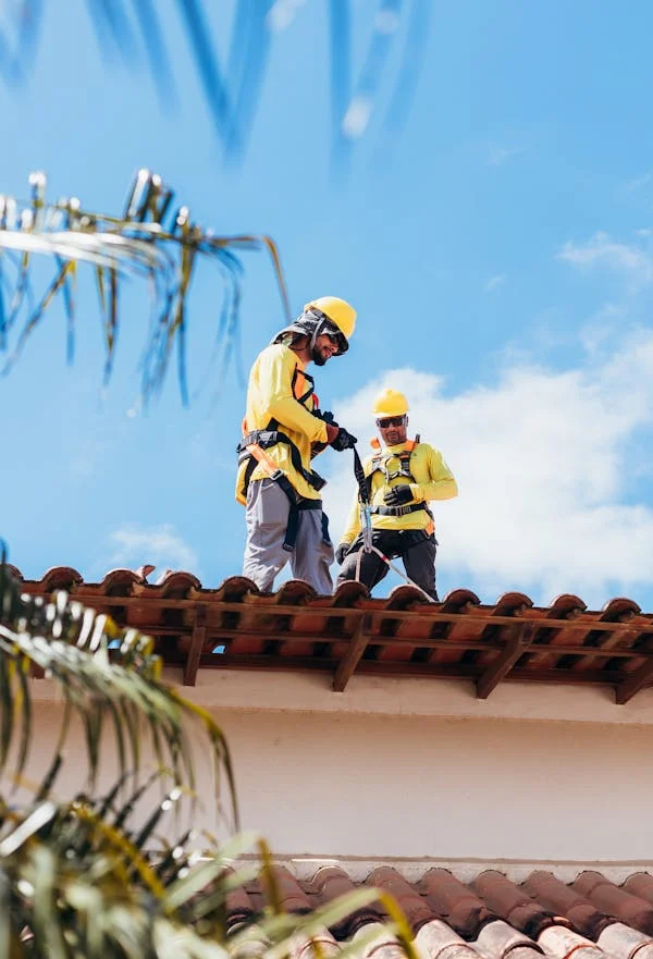 Licensed roofers working on the installation of a roof. Get in touch with us today to get your free estimate.