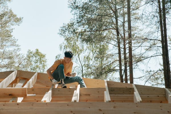 A professional roofer working on the installation of a new roof. To get an estimate, call us today.