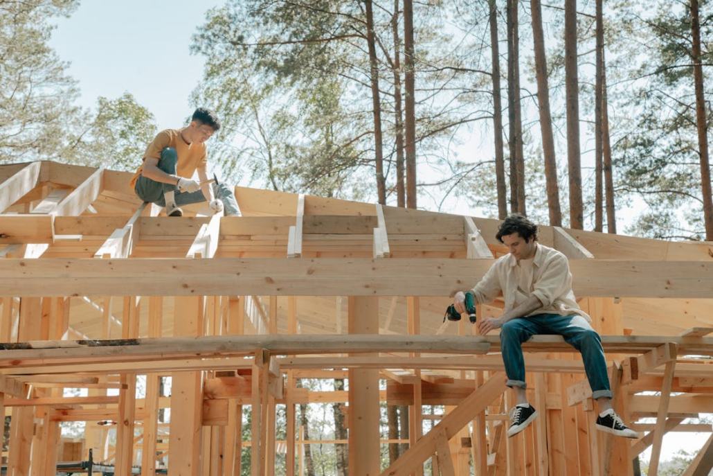 Two licensed roofers working on the installation of a roof. Contact us today to get your free estimate.