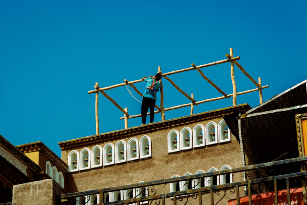 A licensed roofer working on the repair of a residential rooftop. Get your free estimate from us today.