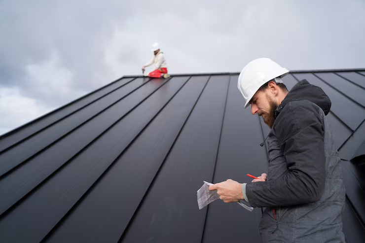 Expert roofers working on the installation of a roof. To get an estimate, get in touch with us today.