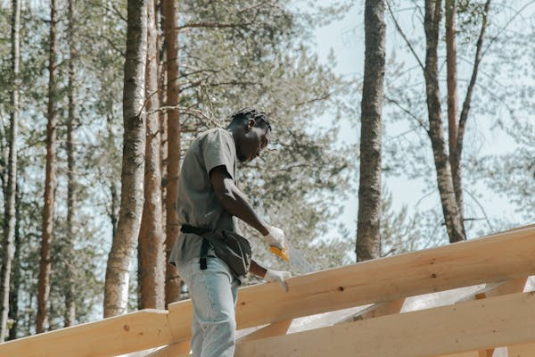 A licensed roofer working on the installation of a roof. Reach out to us today to get your free estimate.