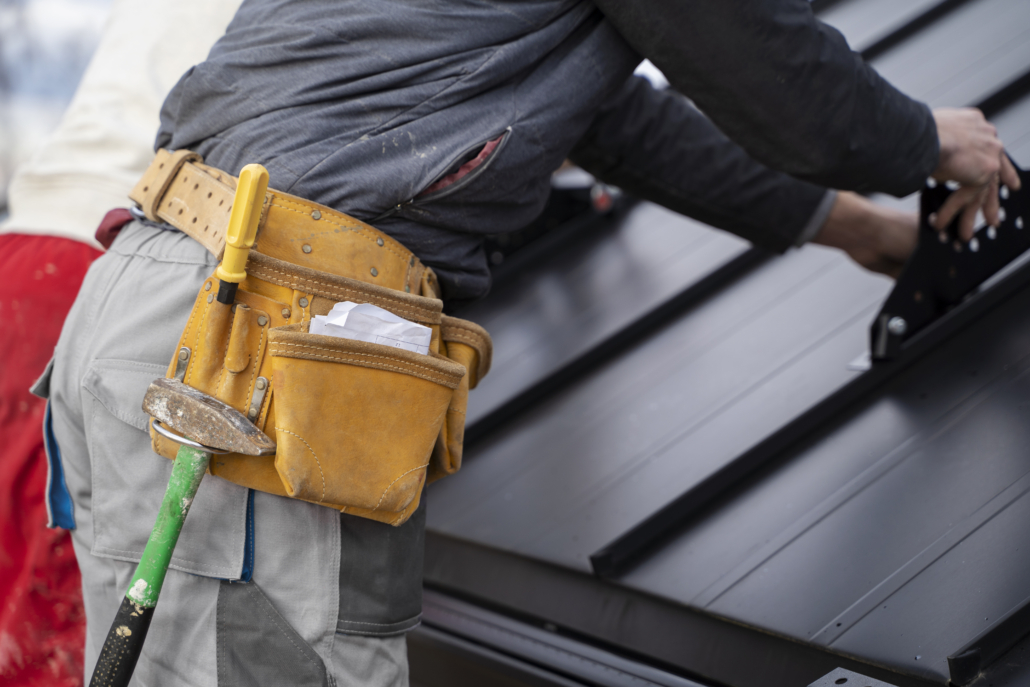 An expert roofing contractor working on the installation of a residential roof. Get your free estimate today by contacting us.