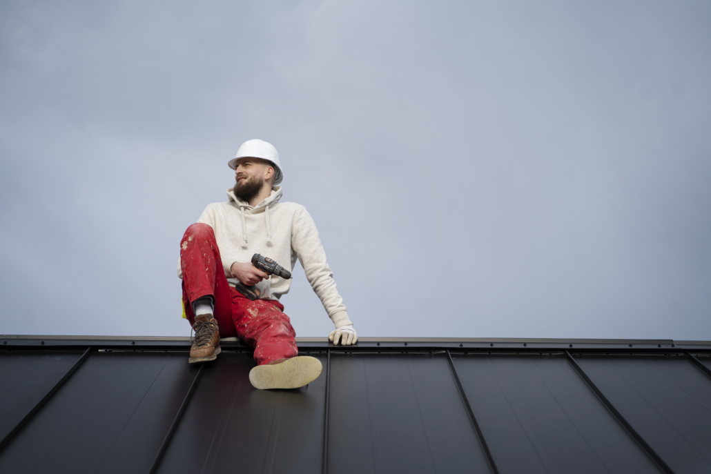 Experienced roofers working on the construction of a commercial building roof. Get your free estimate today.