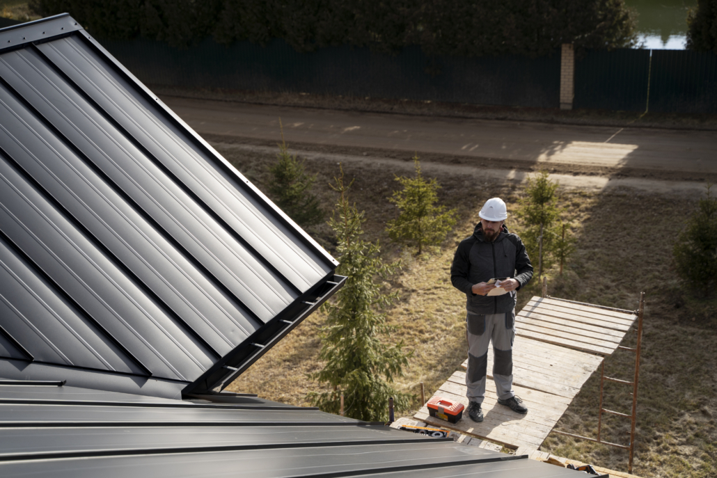Certified roofing contractors working on a building rooftop. Get in touch with us today for your free estimate.