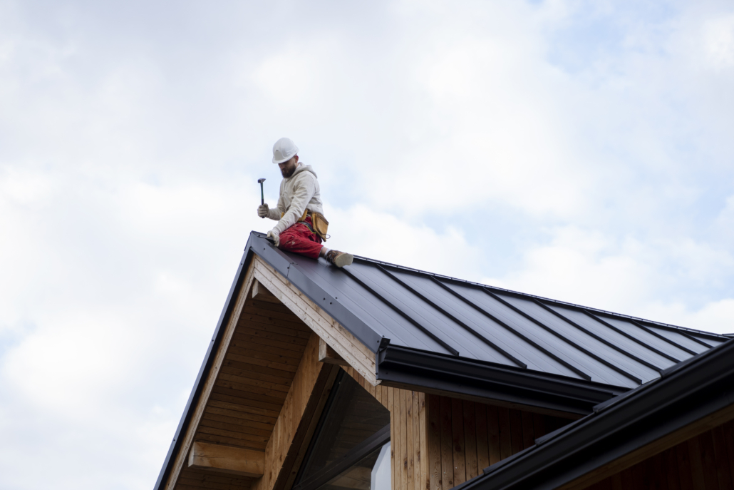 Licensed roofers working on the construction of a rooftop. Reach out to us today for a free estimate.