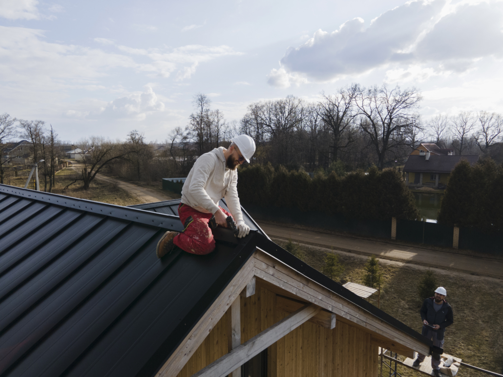 A licensed roofer working on the installation of a commercial rooftop. Get your free estimate today.