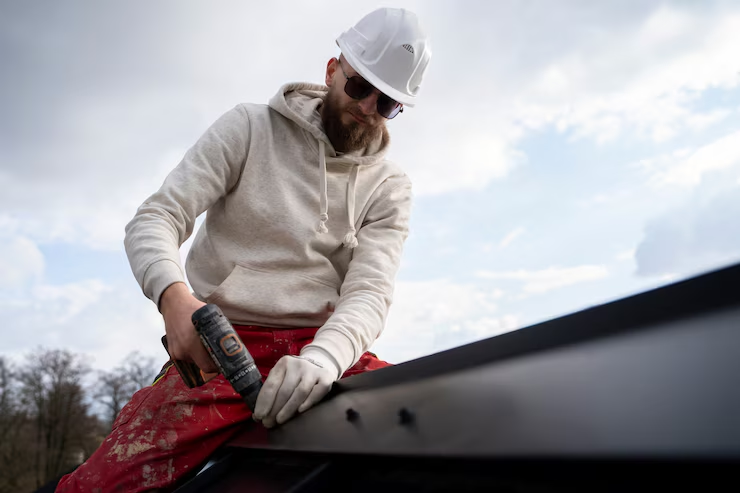 A professional roofer working on the repair of a roof. Get an estimate today by reaching out to us today.