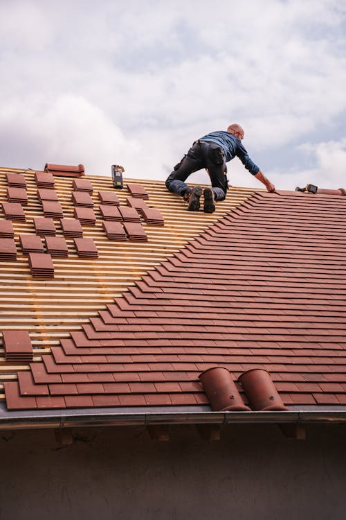 An expert roofer working on the installation of a new roof. Get in touch today for a free estimate.