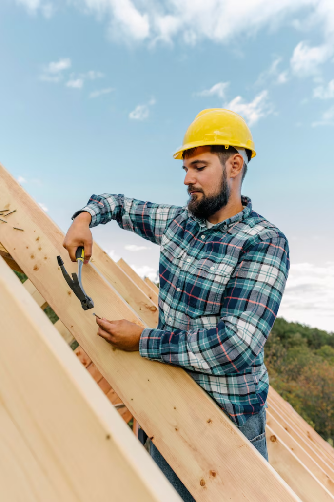 A licensed roofing installing a wooden framework for a roof. Reach out to us today and get a free estimate.