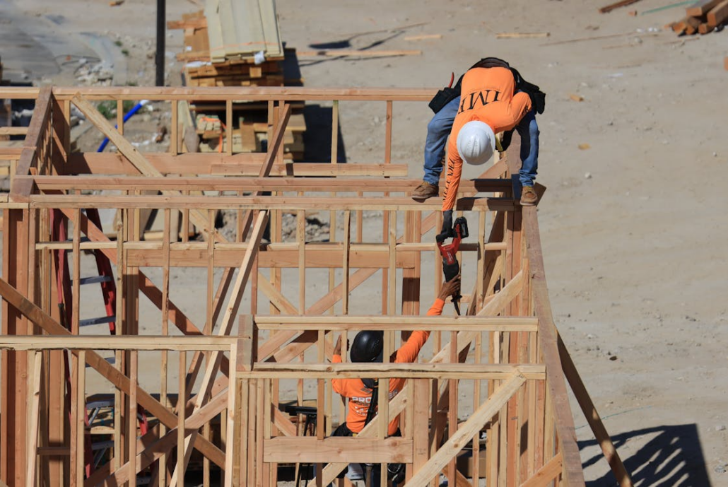 Expert roofers working on the construction of a residential roof. Get in touch with us today to receive your free estimate.