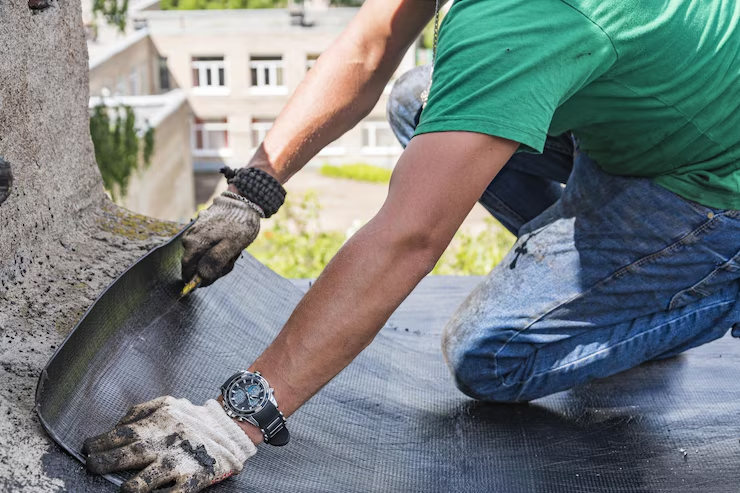 An expert roofing contractor working on the installation of a residential roof. Get your free estimate today by contacting us.