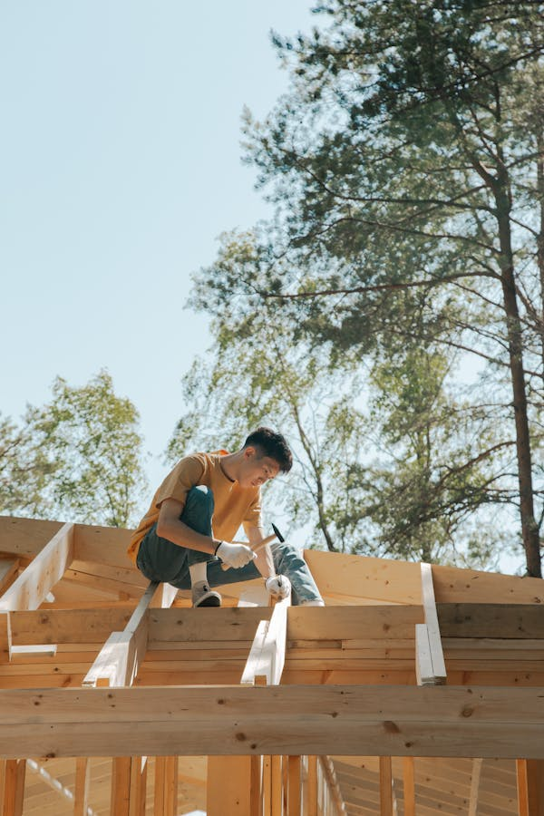 An experienced roofer working on the installation of a roof. Get an estimate today by contacting us.