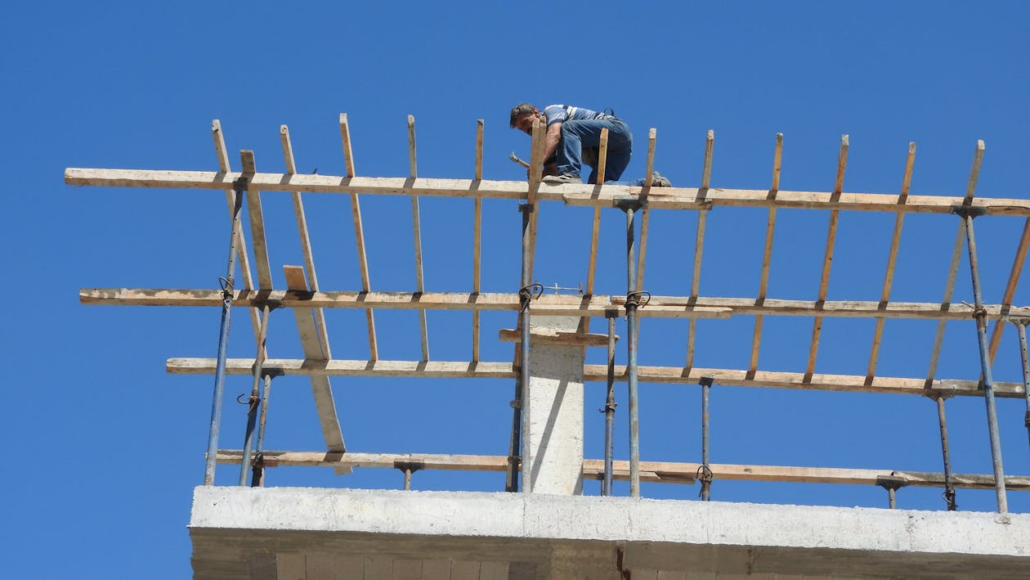 A licensed roofer working on the construction of a residential roof. To get your free estimate, reach out to us today.