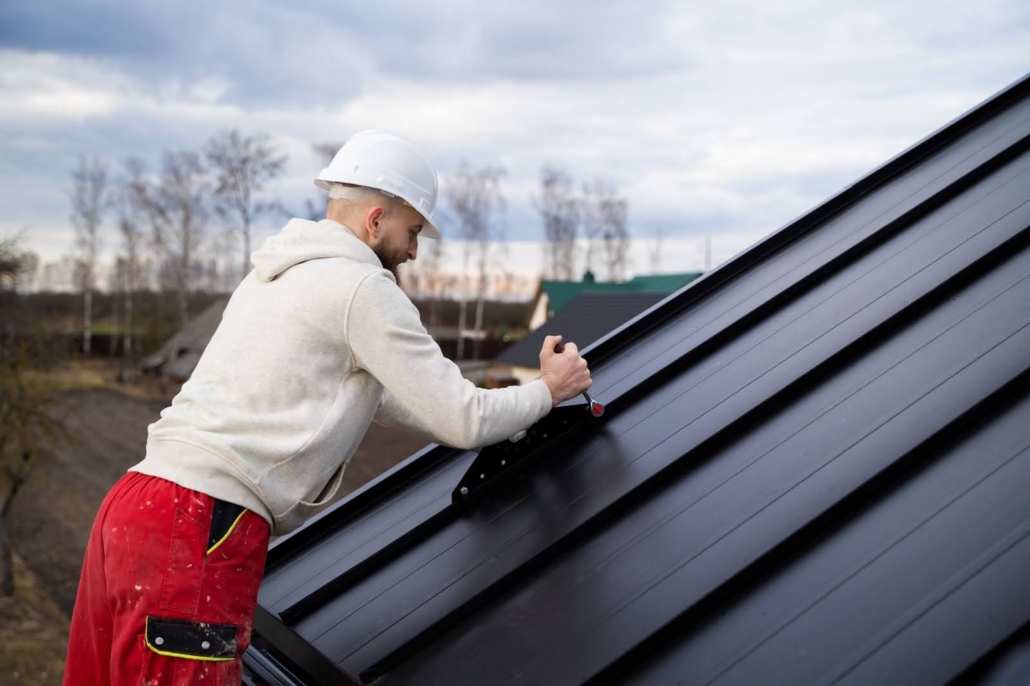 A man taking dimensions before roof installation. To get a free estimate, contact us today.
