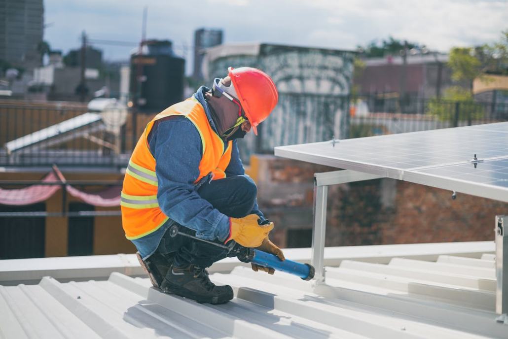 A licensed roofer working on the installation of a roof. Reach out to us today to get your free estimate.