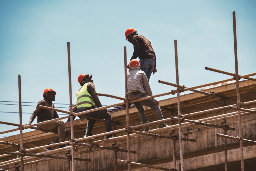 Licensed roofers working on the construction of a rooftop. Reach out to us today for a free estimate.
