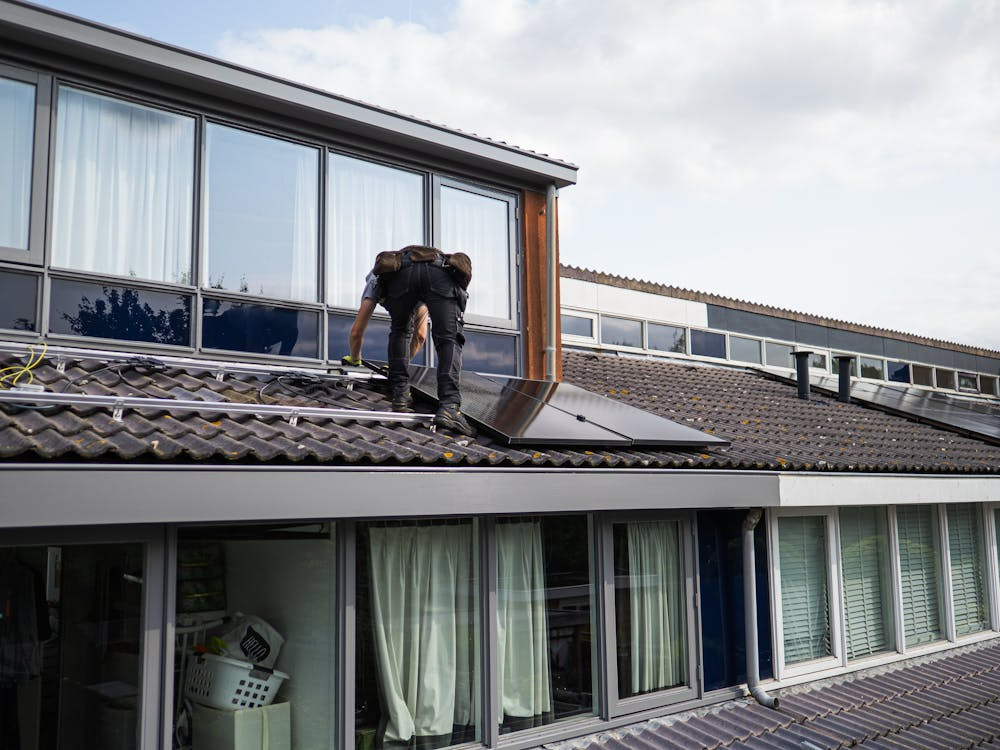 An expert roofer working on the repair of a roof. Get your free estimate today by reaching out to us.