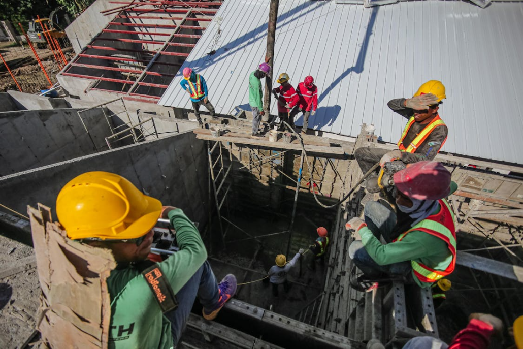 Licensed roofing contractors working on the construction of a roof. Reach out to us today to get your free estimate.