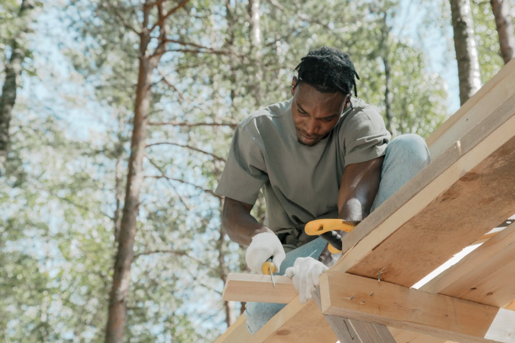 A licensed roofing contractor working on the installation of a roof. Get in touch with us today and receive your free estimate.